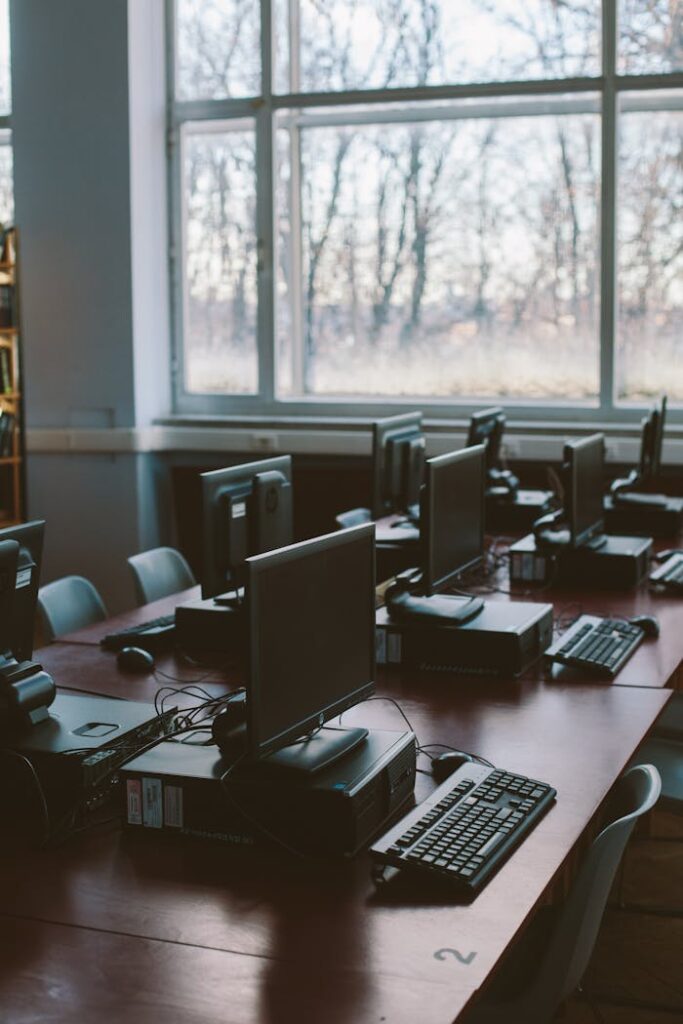 pexels photo 3747481 Spacious computer lab with rows of monitors and keyboards in a sunlit room.